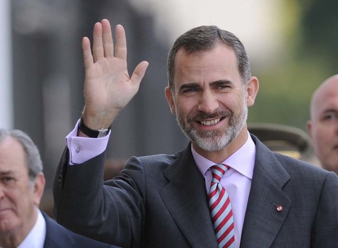 Spanish King Felipe VI waves on arrival before attending the Real Mae